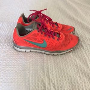 Bright orange Nike running shoes